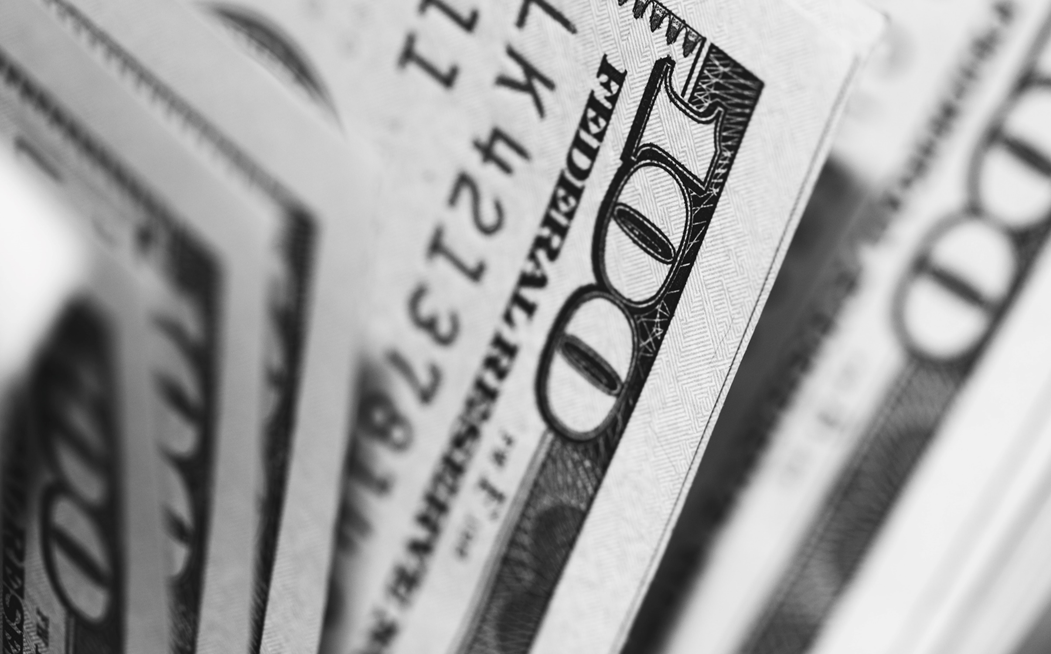 Close-up photograph of ruffled stack of hundred-dollar bills. Image credit: Pepi Stojanovski/Unsplash