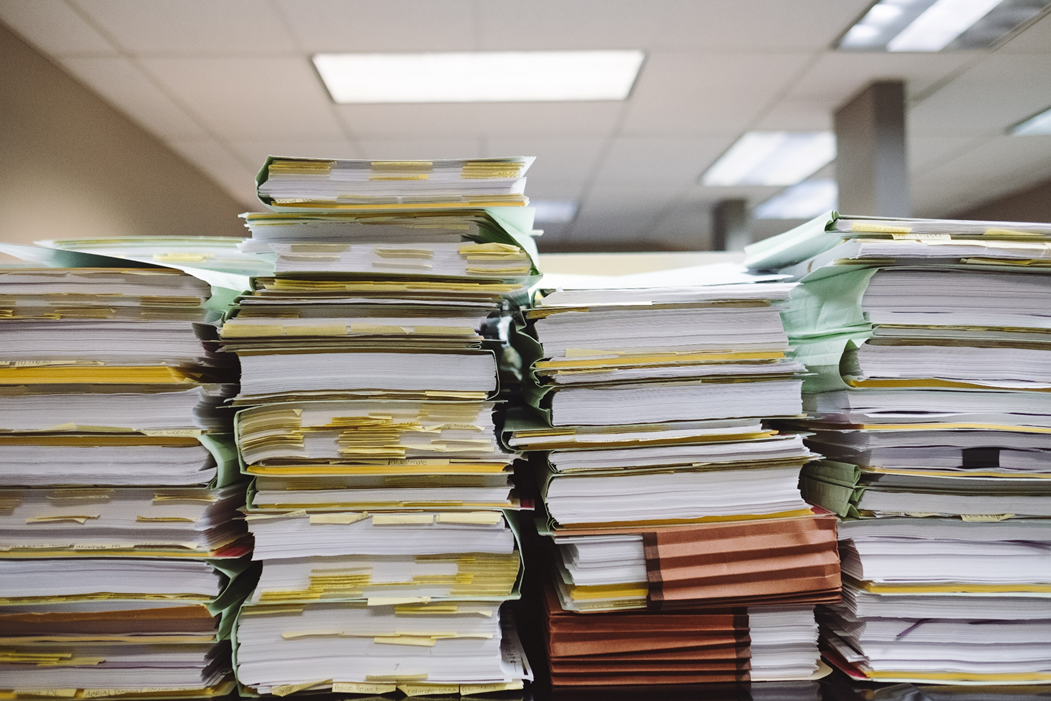 Stacks of paper and binders with sticky note tabs sticking out from pages. Image credit: Stacks of paper and binders with sticky note tabs sticking out from pages. Image credit: Wesley Tingey/Unsplash