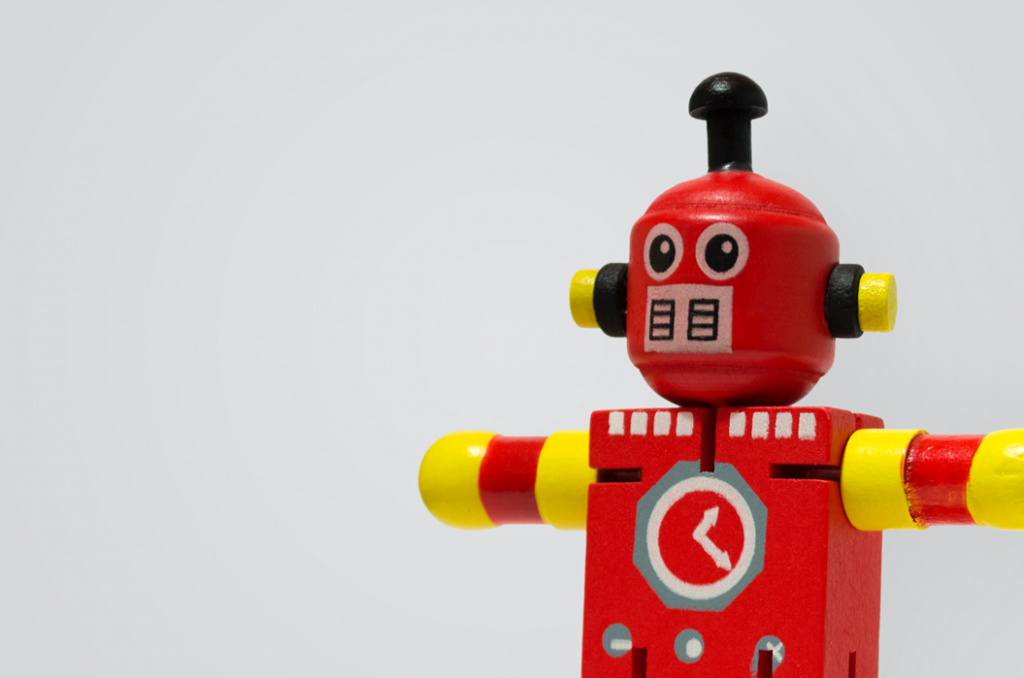 Red and yellow toy robot with arms stretched out as if offering a hug. Image credit: Tincho Franco/Unsplash