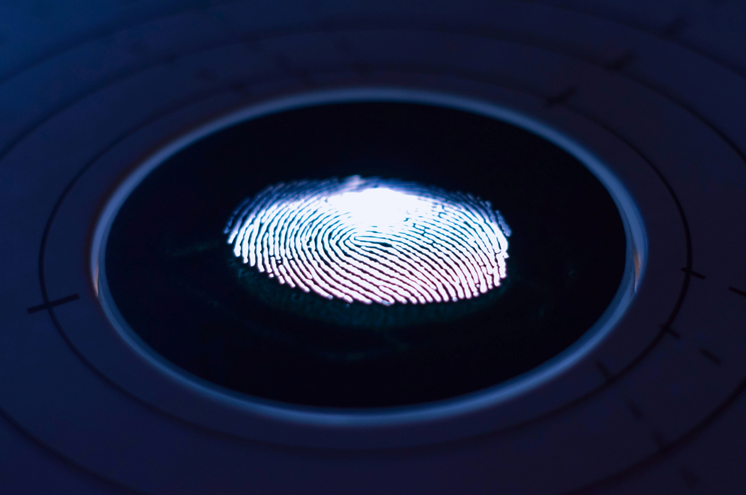 Photo of an illuminated fingerprint on a glass slide. Image credit: George Prentzas/Unsplash