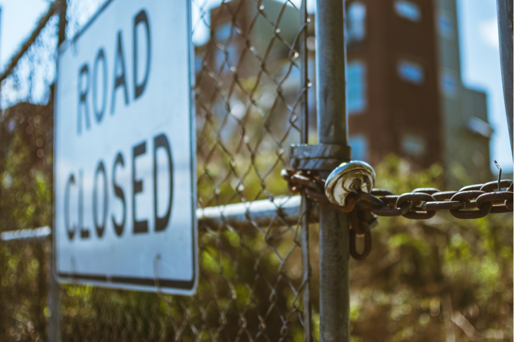 Barrier fencing with a sign that reads “Road Closed”. Image credit: Travis Saylor/Pexels