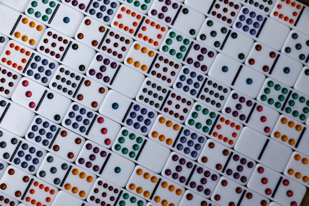 Photograph of domino tiles with colored dots for indicating numerical value. Image credit: Mick Haupt/Unsplash