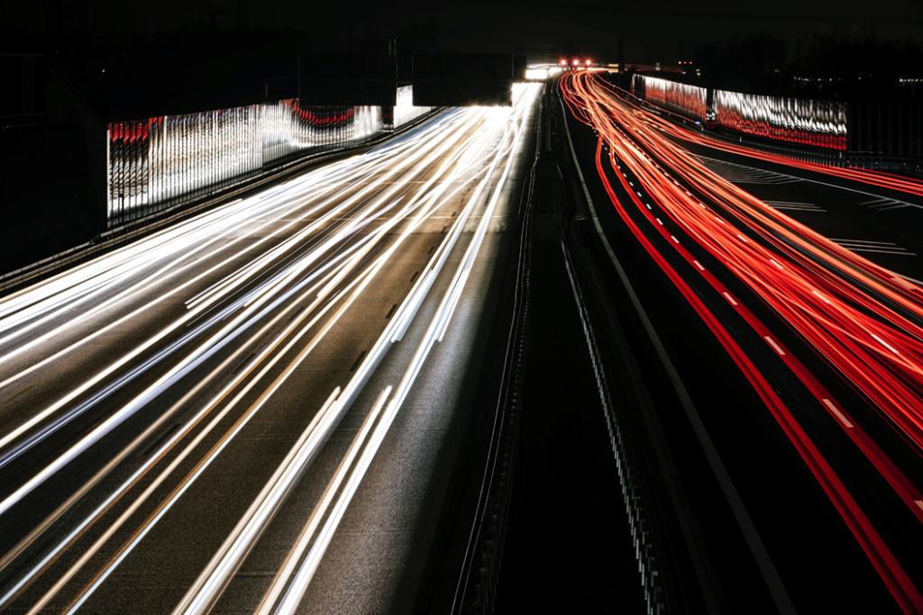 Time-lapse photograph showing busy nighttime traffic on an urban expressway. Image credit: Markus Spiske/Unsplash