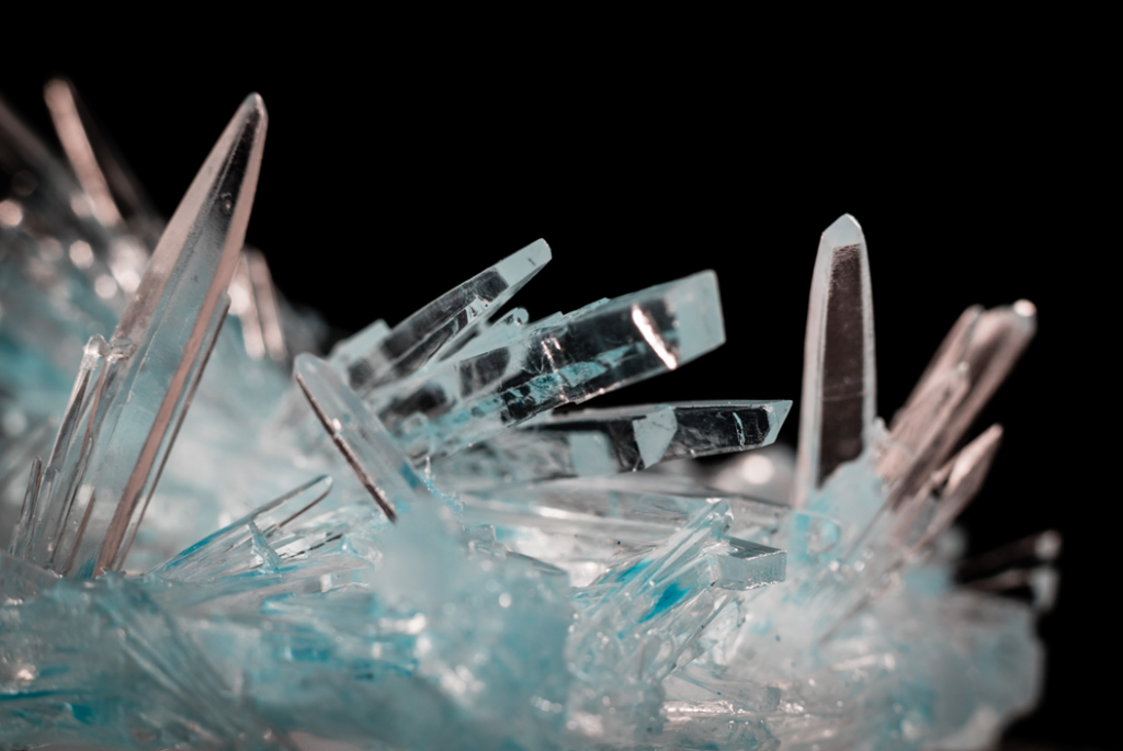 Clear crystal formation (possibly calcite or quartz) against a dark background. Image credit: Jason D/Unsplash