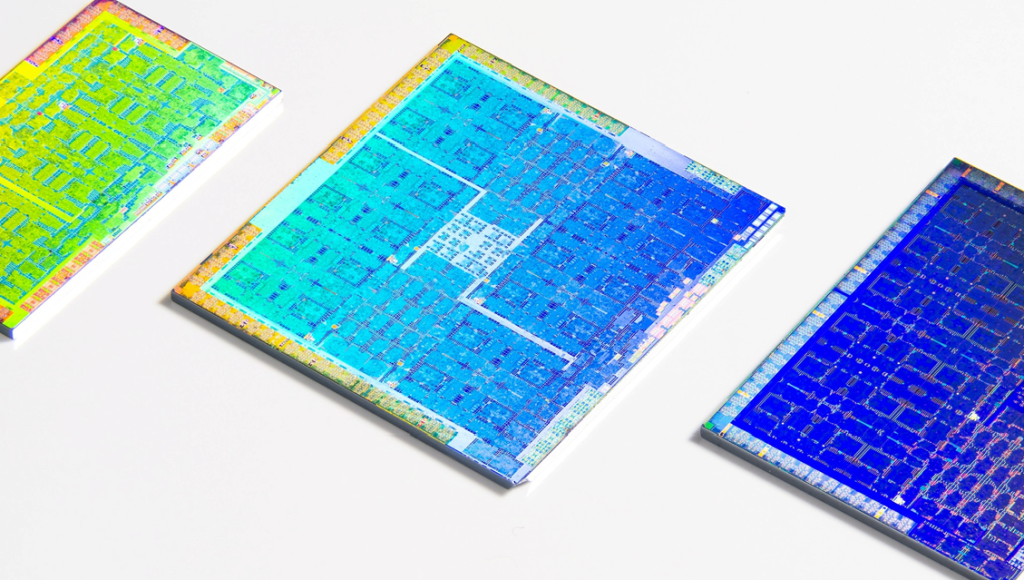 Three colorful GPUs with their packaging cleanly removed laying on a white surface. Image credit: Fritzchens Fritz / Better Images of AI / GPU shot etched 2 / CC-BY 4.0
