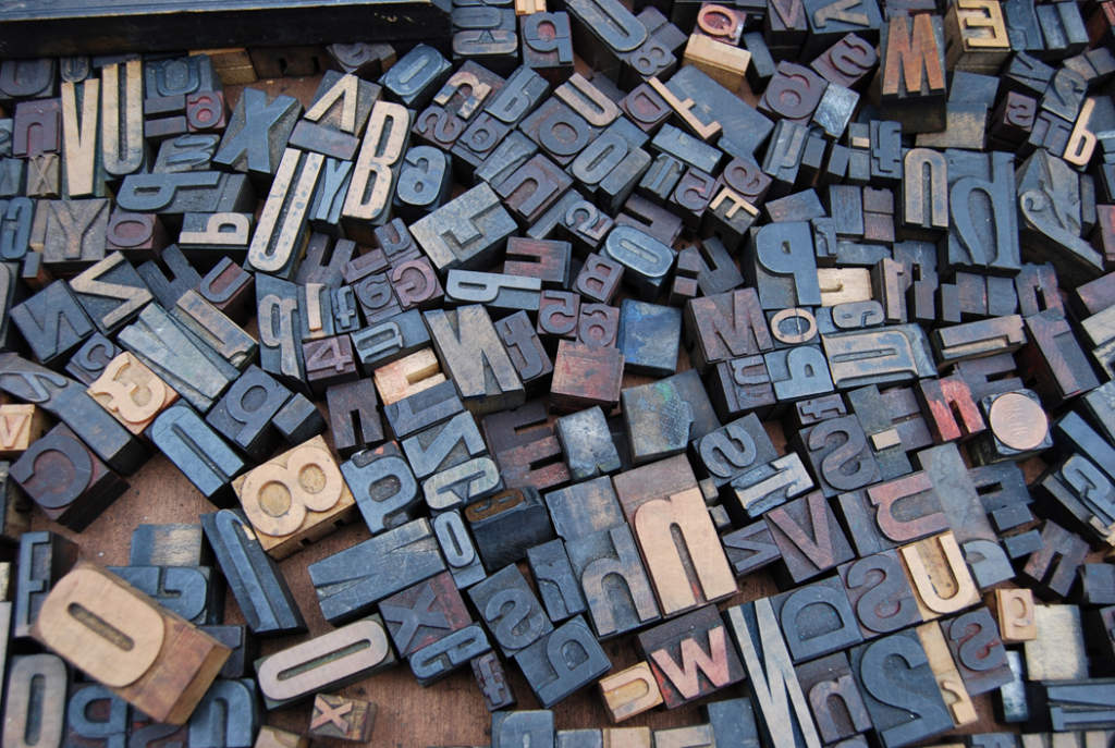 A jumble random jumble of old-fashioned moveable type letters and words. Image credit: Amador Loureiro/Unsplash