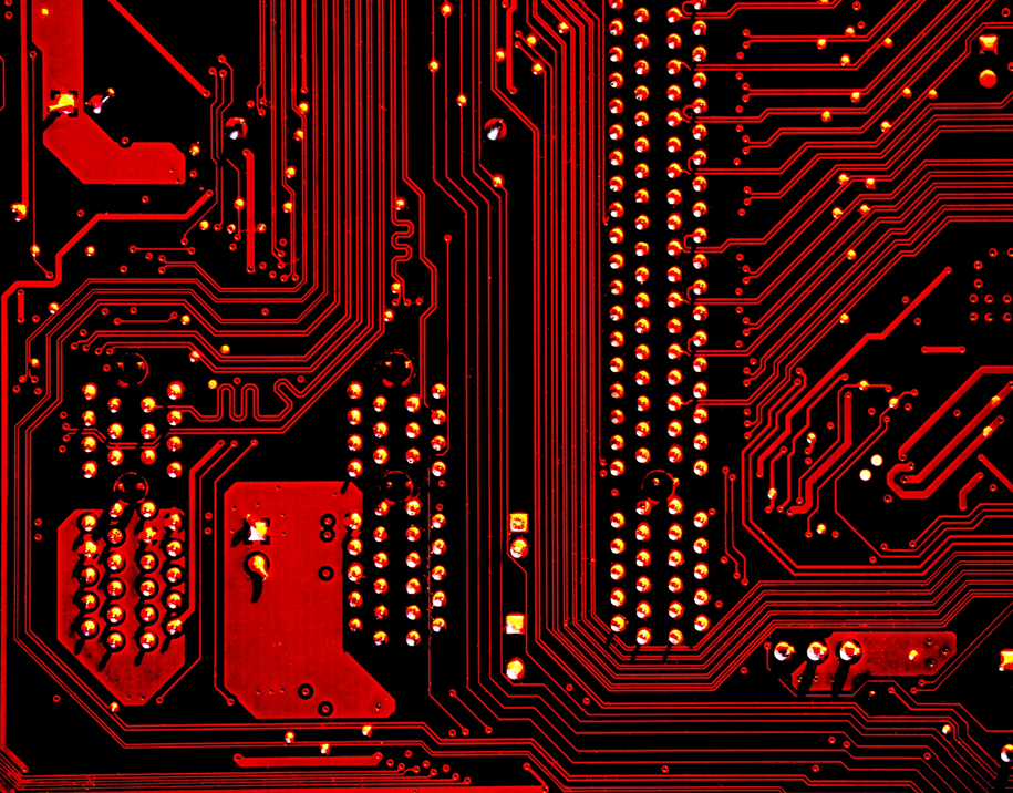 Red-lit photograph of a computer processor’s circuitry. Image credit: Michael Dziedzic/Unsplash