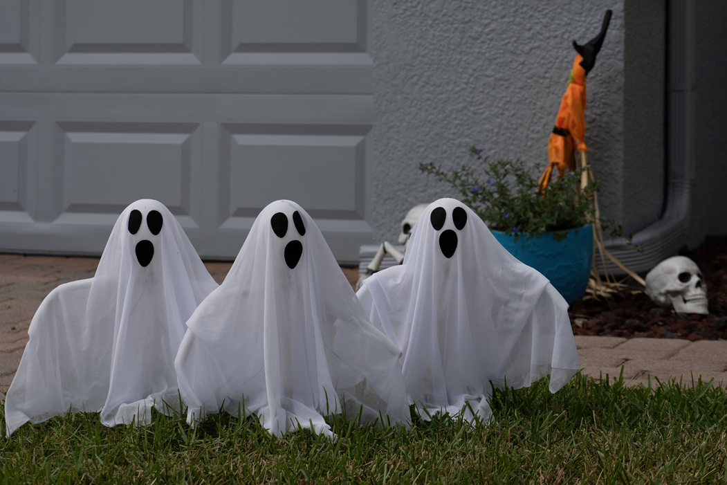 Small, comical ghost figures on a lawn as part of a Halloween decoration. Image credit: Dawn McDonald