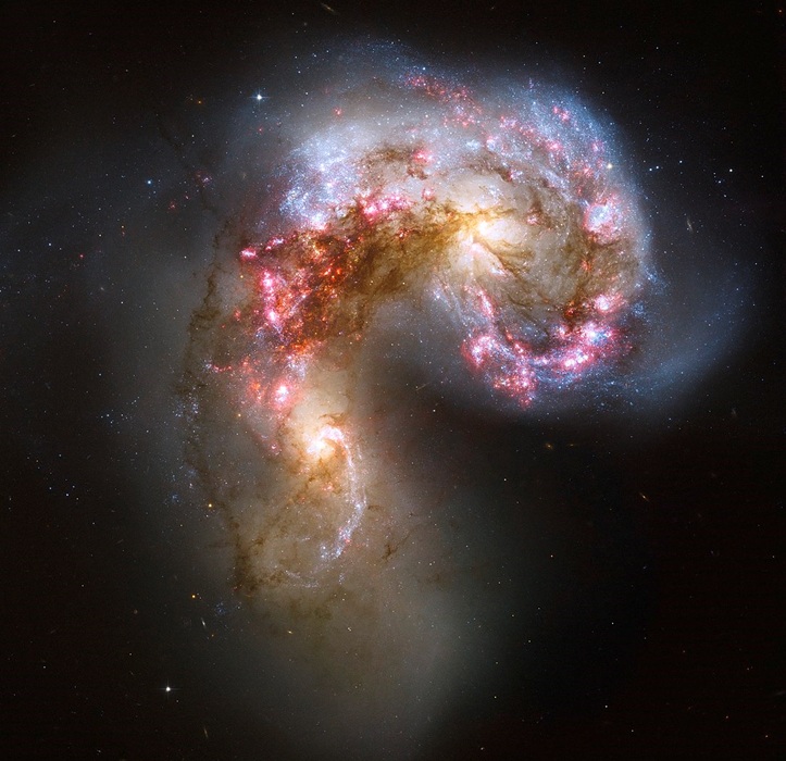 Hubble Space Telescope photograph of the swirled and irregular shape of the Antennae Galaxies, two spiral galaxies whose shapes are being distorted by gravity as the two galaxies merge with each other. Image credit: NASA/ESA/Hubble Heritage