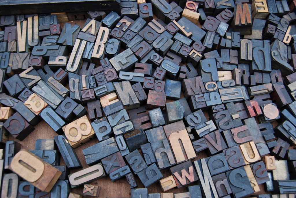 Disorderly jumble of moveable type letters from an old-fashioned mechanical printing press. Image credit: Amador Loureiro/Unsplash