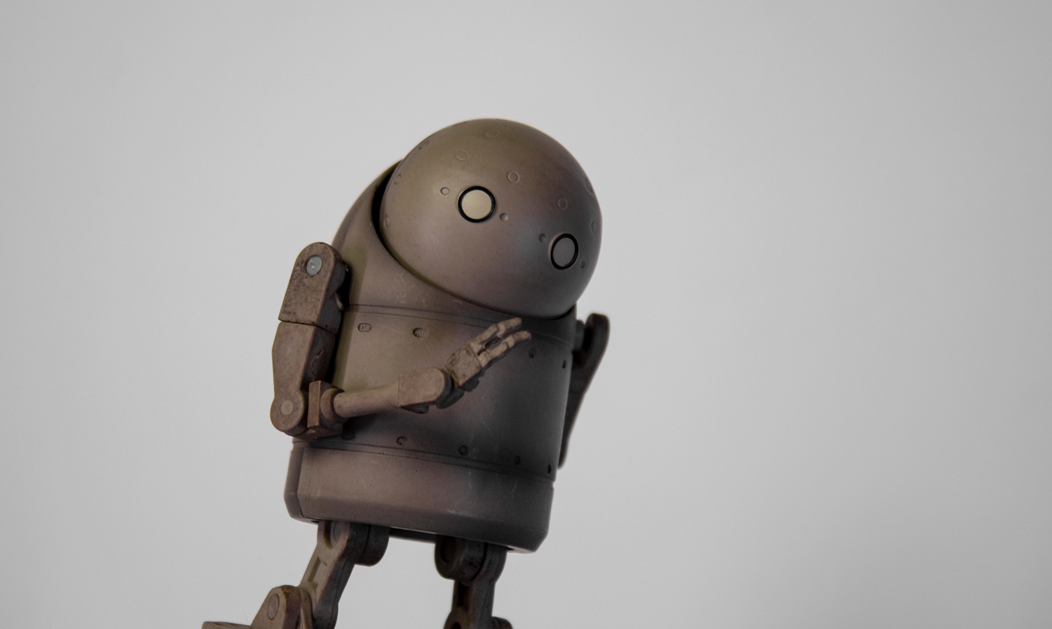 A computer art rendering of a stylized cylindrical robot, posed as if thinking or perplexed. Image credit: Anton Maksimov/Unsplash
