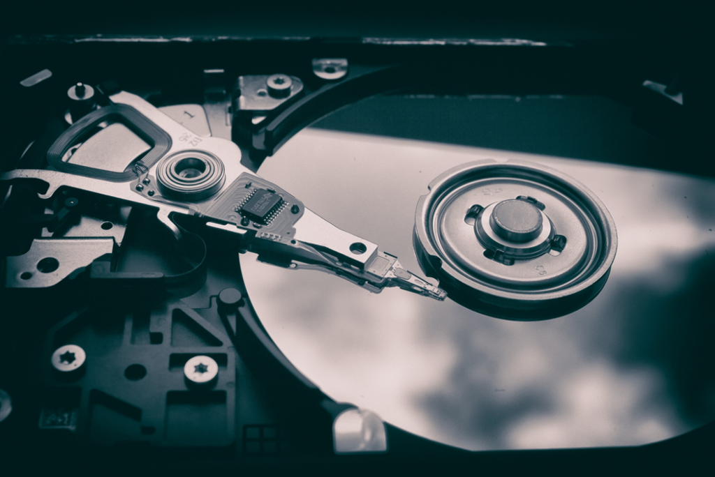Closeup photo of the polished disk of an optical computer drive with other internal components. Image credit: Patrick Lindberg/Unsplash