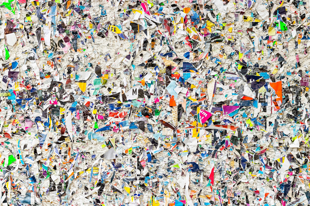 Shredded and torn remnants of posters and handbills stapled to a wall. Image credit: Jan Huber/Unsplash