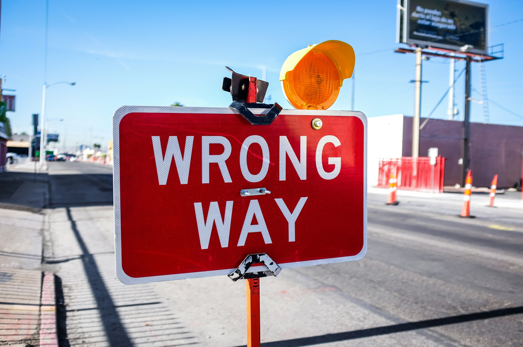 Road sign reading WRONG WAY photographed in a construction zone. Image credit: Kenny Eliason/Unsplash.